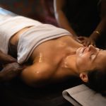 Guest receiving synchronized Ayurvedic oil massage therapy at Kairali Ayurvedic Health Village in Kerala during a Panchakarma retreat.