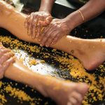 Ayurvedic leg massage with herbal paste at Kairali Ayurvedic Health Village in Kerala.