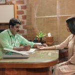 Ayurvedic doctor performing pulse diagnosis on a female patient at Kairali Ayurvedic center