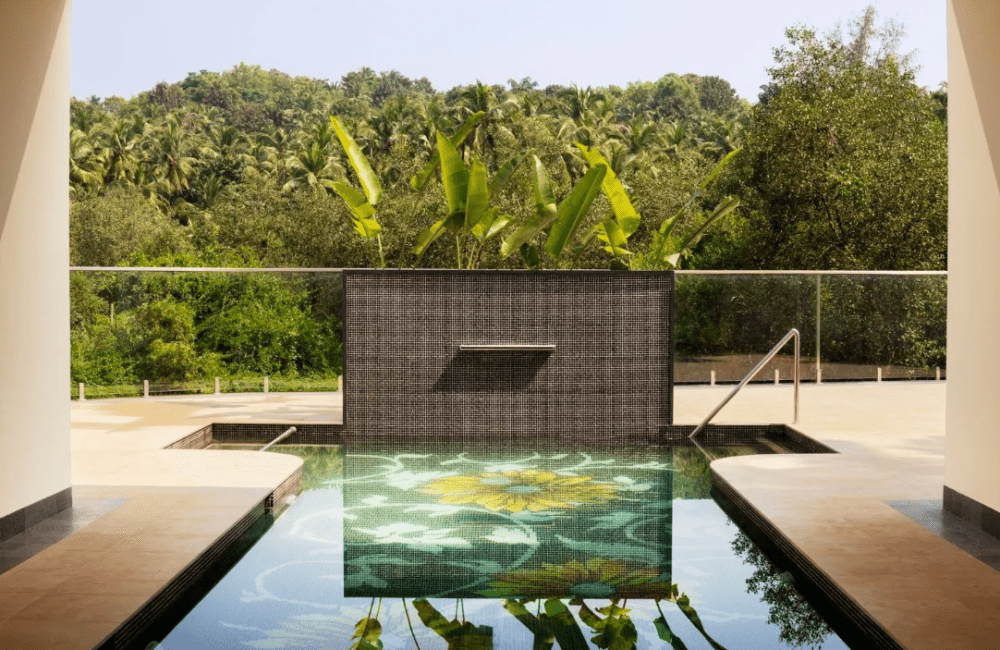 Infinity pool with lotus tile design and forest view at Villa Raag, Kairali Ayurvedic Group’s luxury wellness retreat in Goa.