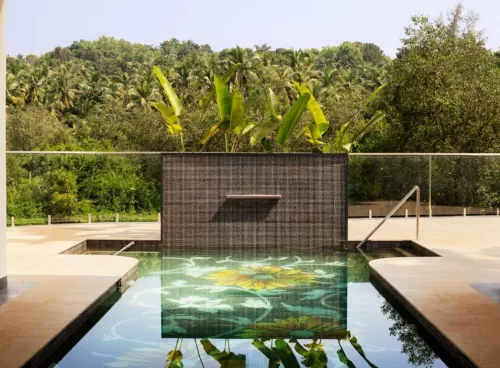 Infinity pool with lotus tile design and forest view at Villa Raag, Kairali Ayurvedic Group’s luxury wellness retreat in Goa.