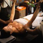 Ayurvedic Abhyanga oil therapy at Kairali Ayurvedic Healing Village, two therapists performing synchronized massage on a guest to support relaxation and metabolic balance