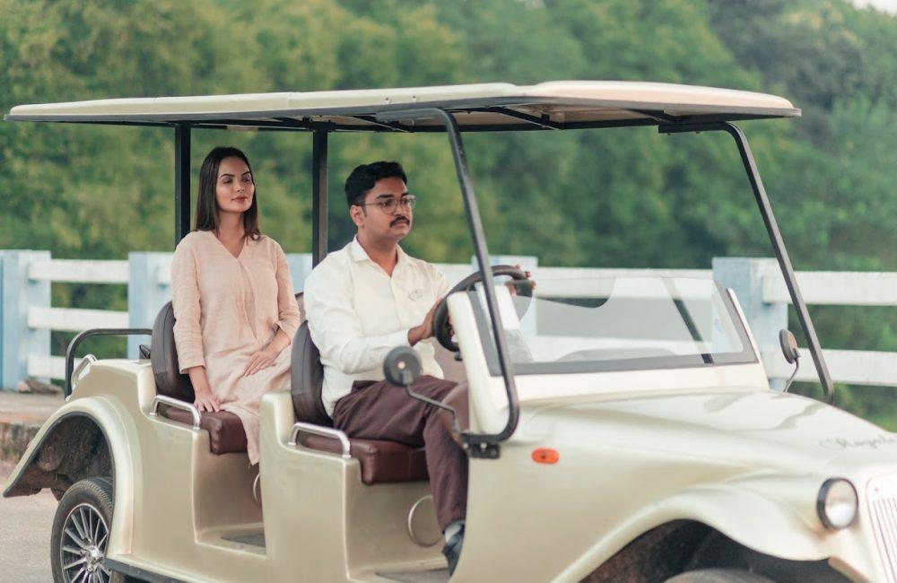 Solo female guest escorted in a vintage buggy by Kairali staff inside a serene Kerala Ayurveda retreat campus