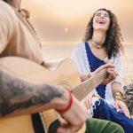 Couple at sunset on Agonda Beach, Goa—live guitar, laughter, and privacy at an exclusive beach villa in India.