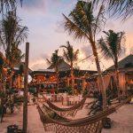 Sunset beach lounge with hammocks, string lights, and palm trees at an Agonda beachfront stay