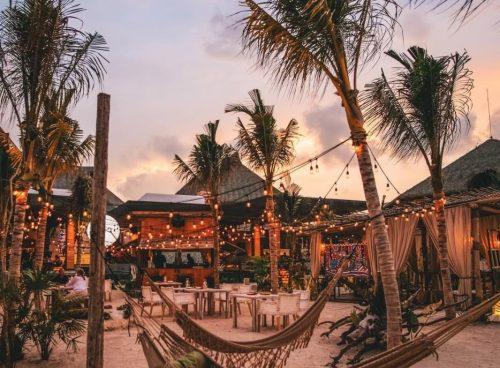 Sunset beach lounge with hammocks, string lights, and palm trees at an Agonda beachfront stay
