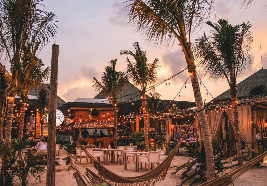 Sunset beach lounge with hammocks, string lights, and palm trees at an Agonda beachfront stay