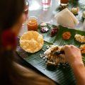 Guest enjoying a Kerala banana-leaf meal—rice, dal, papad and seasonal veg sides—at Kairali Ayurvedic Healing Village.