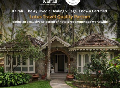 Front view of a heritage villa at Kairali – The Ayurvedic Healing Village in Kerala, surrounded by coconut palms and gardens, with text announcing its certification as a Lotus Travel Quality Partner 2026.