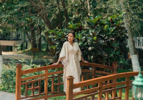 Woman enjoying a quiet moment in nature after an Ayurvedic retreat, reflecting calm and balance before returning home