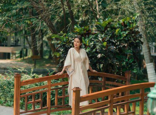 Woman enjoying a quiet moment in nature after an Ayurvedic retreat, reflecting calm and balance before returning home