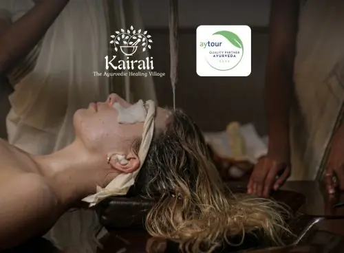 Shirodhara therapy being performed at Kairali – The Ayurvedic Healing Village, with an overlay noting “Aytour Quality Partner – Ayurveda 2026.