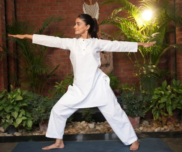 International Yoga Day 2026 yoga session featuring a participant practising a standing yoga posture in a wellness setting