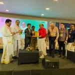Award presentation on stage at the International Ayurveda & Wellness Conclave 2026, honoring excellence in wellness and Ayurveda tourism.