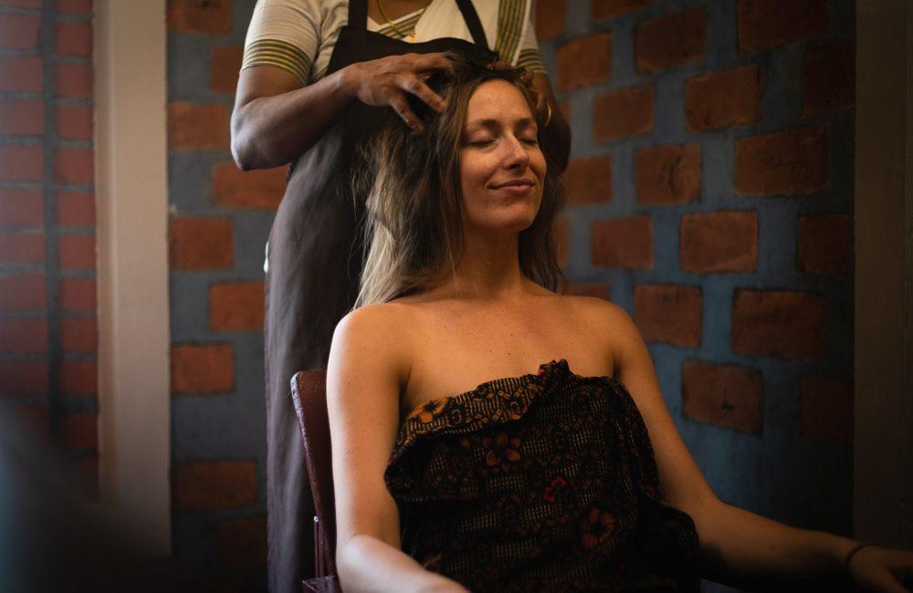 Woman receiving an Ayurvedic head massage at Kairali’s healing village in Kerala