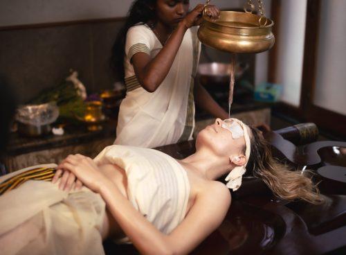 Ayurvedic Shirodhara therapy at Kairali Healing Village Kerala for addiction detox and mental relaxation