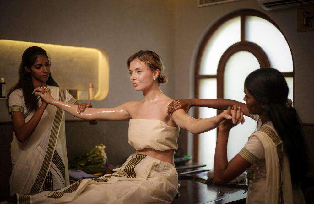 Ayurvedic Abhyanga therapy at Kairali Ayurvedic Healing Village Palakkad showing synchronized oil massage for holistic wellness