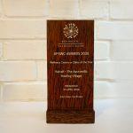 Wooden award plaque from the Asia Pacific Spa & Wellness Coalition, engraved with "APSWC Awards 2026 – Wellness Centre or Clinic of the Year – Kairali – The Ayurvedic Healing Village – Presented 24 April 2026, Siem Reap, Cambodia.