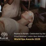 A therapist performs Shirodhara, an Ayurvedic treatment, pouring a stream of warm oil onto the forehead of a woman lying peacefully on a treatment table, with eye pads and ear coverings in place.