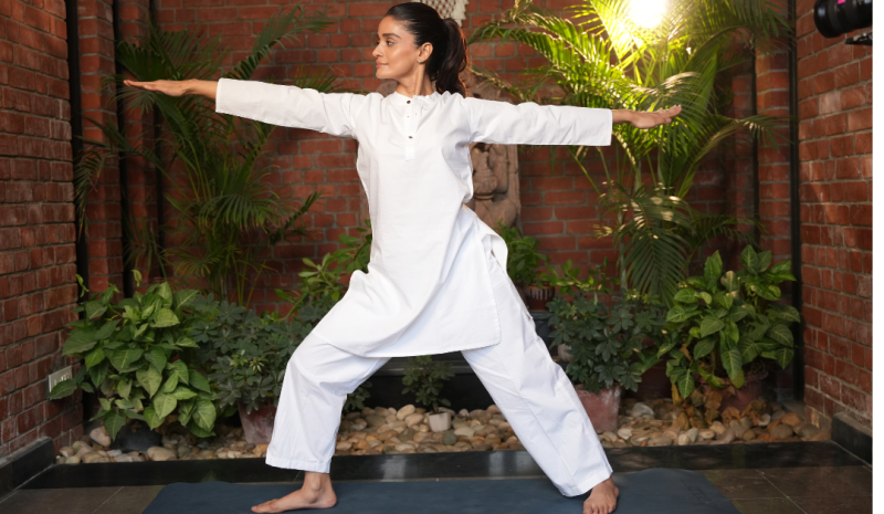 International Yoga Day 2026 yoga session featuring a participant practising a standing yoga posture in a wellness setting