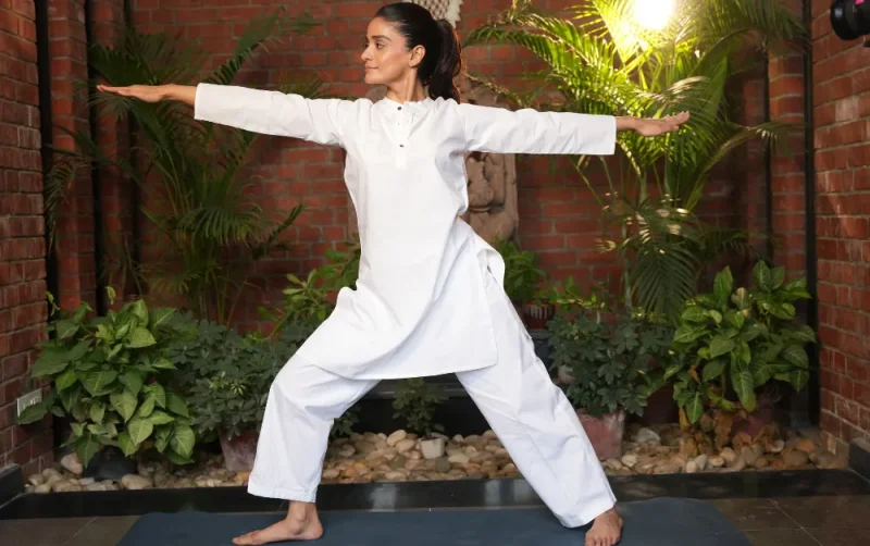 International Yoga Day 2026 yoga session featuring a participant practising a standing yoga posture in a wellness setting