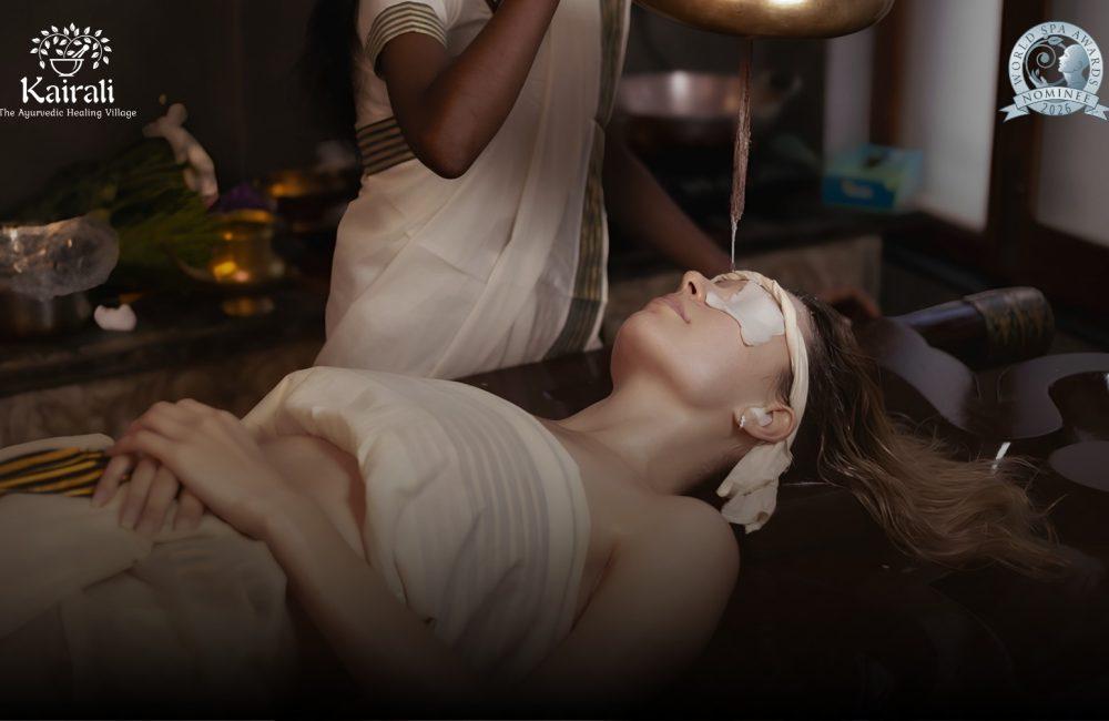 Guest receiving a traditional Ayurvedic therapy at Kairali – The Ayurvedic Healing Village, a World Spa Awards 2026 nominee, in a serene treatment setting in Kerala.