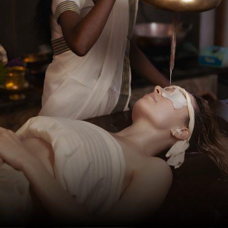 Guest receiving a traditional Ayurvedic therapy at Kairali – The Ayurvedic Healing Village, a World Spa Awards 2026 nominee, in a serene treatment setting in Kerala.