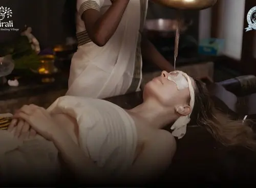 Guest receiving a traditional Ayurvedic therapy at Kairali – The Ayurvedic Healing Village, a World Spa Awards 2026 nominee, in a serene treatment setting in Kerala.
