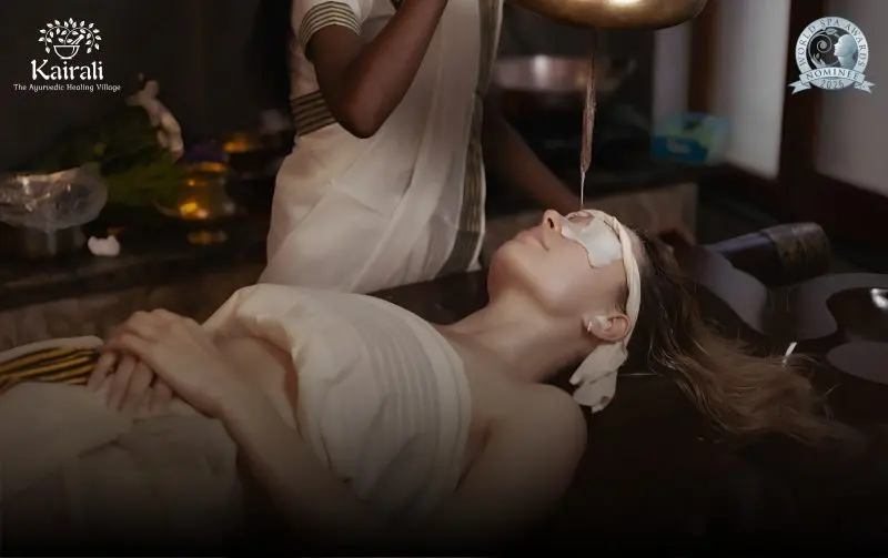 Guest receiving a traditional Ayurvedic therapy at Kairali – The Ayurvedic Healing Village, a World Spa Awards 2026 nominee, in a serene treatment setting in Kerala.