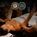Kairali Ayurvedic therapists performing a traditional Ayurvedic oil therapy at Kairali – The Ayurvedic Healing Village, recognised at the 2026 Haute Grandeur Global Excellence Awards.