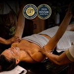 Kairali Ayurvedic therapists performing a traditional Ayurvedic oil therapy at Kairali – The Ayurvedic Healing Village, recognised at the 2026 Haute Grandeur Global Excellence Awards.