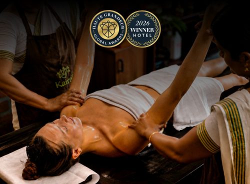 Kairali Ayurvedic therapists performing a traditional Ayurvedic oil therapy at Kairali – The Ayurvedic Healing Village, recognised at the 2026 Haute Grandeur Global Excellence Awards.