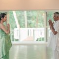 Wellness expert greets guest with namaste before guiding her on common yoga mistakes beginners make