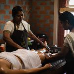 Ayurvedic oil therapy being performed by two therapists at Kairali – The Ayurvedic Healing Village in Kerala.