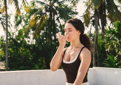 Woman practising alternate-nostril breathing outdoors at a tropical wellness retreat.