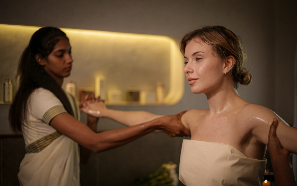 Ayurveda for perimenopause with a woman receiving a physician-guided Ayurvedic oil therapy from a female practitioner.Ayurveda for Ayurveda for perimenopause with a woman receiving a physician-guided Ayurvedic oil therapy from a female practitioner.