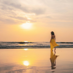 Woman walking along Agonda Beach at sunrise before a sunrise yoga in Goa experience at Villa Raag.