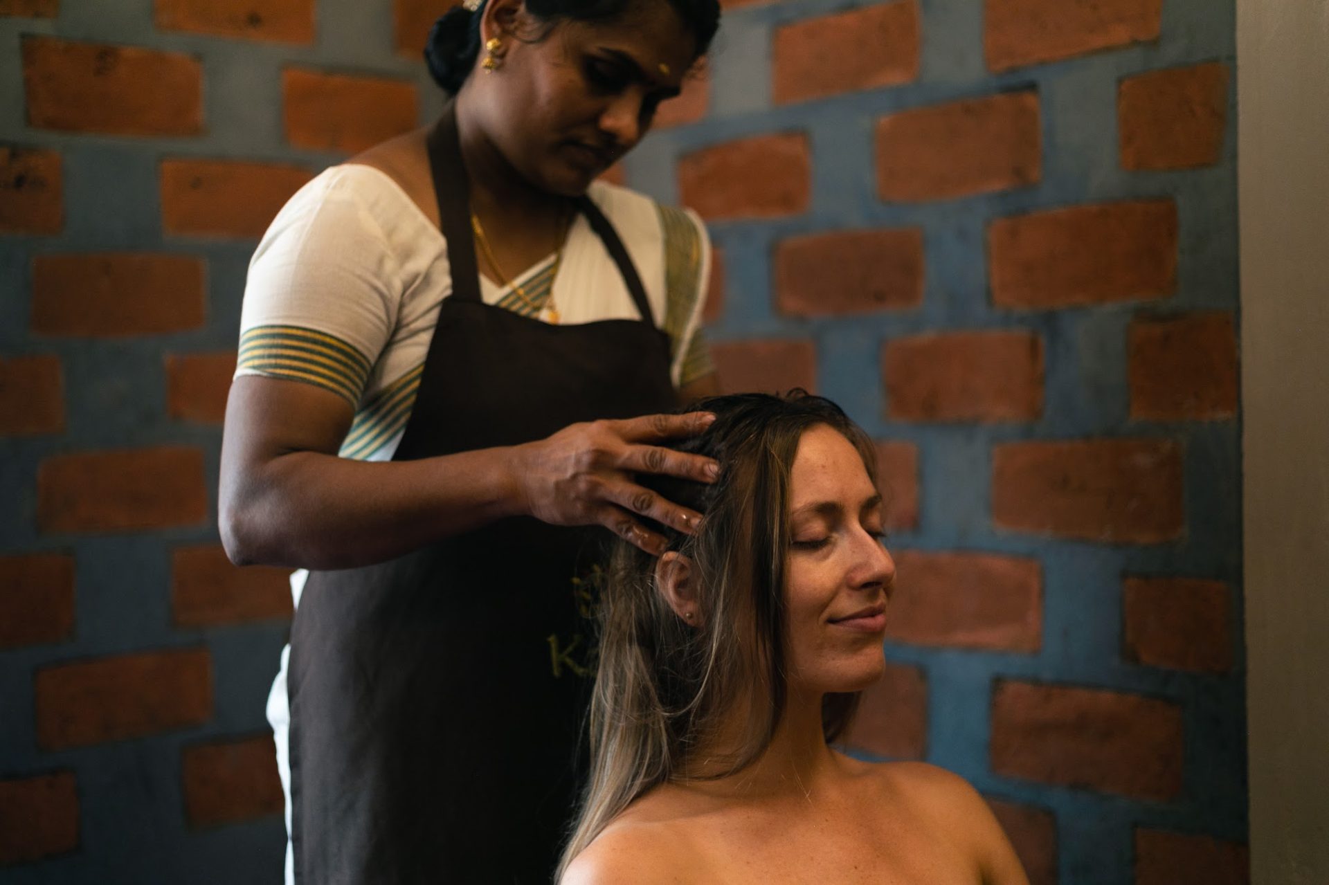 Woman receiving a relaxing Ayurvedic head massage, highlighting preventive mental wellbeing and self-care on World Mental Health Day 2026.